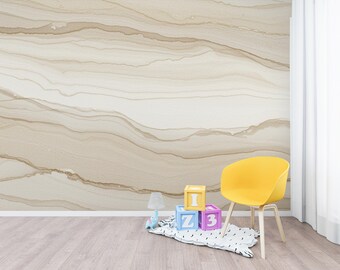 May include: A room with a light wood floor, a yellow chair, and a wall with a beige and brown abstract design. Colorful alphabet blocks and a small lamp are on the floor.