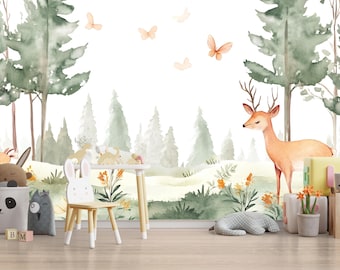 May include: Watercolor forest scene with a deer, butterflies, and trees. Includes a white table and chair, stuffed animals, and blocks. The color palette features greens, browns, and oranges, creating a whimsical nursery theme.