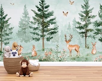 May include: A whimsical forest-themed mural with watercolor trees, deer, and rabbits. A woven basket holds plush toys, including a bear, panda, and dog. A brown monkey sits in front of the basket, and a beige tote bag is nearby.