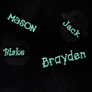 May include: A black background with four names written in a light green color: Mason, Jack, Blake, and Brayden.