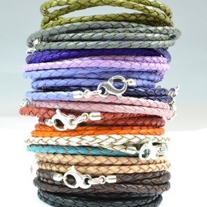 May include: A stack of 16 leather cords in various colors, including olive, gray, violet, lilac, light purple, dark blue, pink, red, orange, white, turquoise, natural, brown, and black. Each cord has a silver clasp.