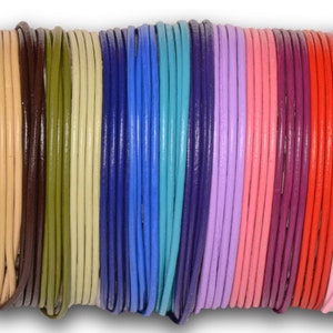 May include: Assortment of 20 leather cords in various colors, including black, brown, beige, green, blue, turquoise, purple, pink, red, and white. The cords are rolled up and arranged in a row.