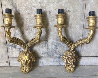 Pair of bronze head wall sconces