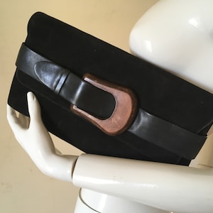 Black suede clutch bag by Carel