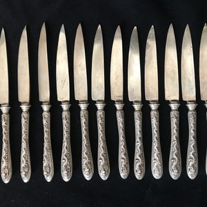 Twelve Chinese silver knives with dragon handles