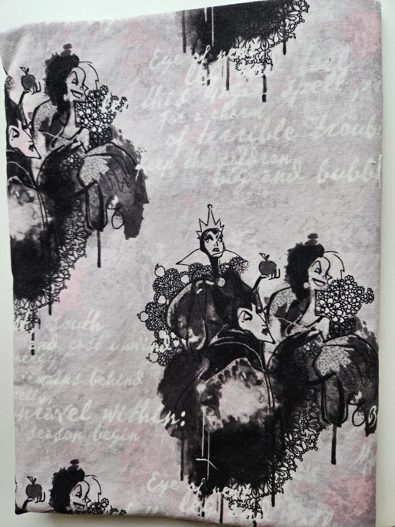 May include: Fabric with a repeating pattern of black and white cartoon illustrations of evil characters on a light gray background. The fabric has text in a cursive font.