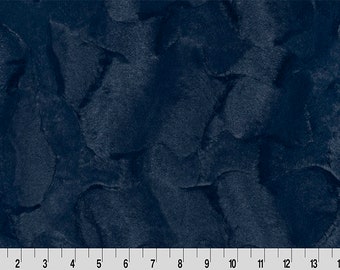 May include: A close-up of a dark blue fabric with a textured, marbled pattern. The fabric has a soft, plush feel.