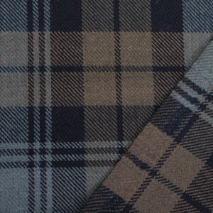 May include: A close-up of a brown, black and grey plaid fabric. The fabric is folded in half, showing the pattern on both sides.