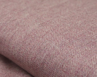 May include: Close-up of a pink and white herringbone fabric. The fabric has a subtle texture and a soft, woven appearance.