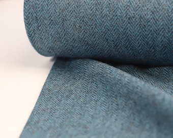 May include: Teal and black herringbone fabric with a textured surface.