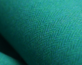 May include: Close-up of a deep teal green fabric with a textured woven pattern.