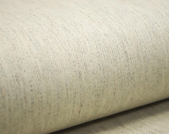 May include: A roll of off-white fabric featuring a subtle, light gray herringbone weave pattern. The textile displays a soft, textured surface with a consistent, repeating diagonal line design throughout the material, captured in a close-up view.
