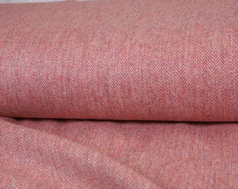 May include: Close-up of a pink and white herringbone fabric. The fabric has a subtle texture and a soft, woven appearance.