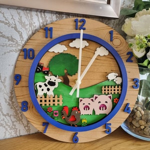 May include: A wooden clock with a blue and white farm scene. The clock face has Roman numerals and a blue border. The scene includes a cow, pigs, a rooster, and a farmhouse.