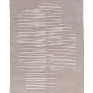 May include: A beige rug with a white geometric design. The design is made up of horizontal lines that create a pattern of overlapping rectangles.