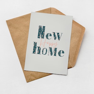 Greenwich Paper Studio, modern & minimal style 'happy new home' card with patterned text and key illustrations, styled laying flat on a brown Kraft envelope.