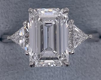 7 Carat Total E Color VVS2 Clarity IGI CERTIFIED Three Stone Emerald Cut Lab Grown Diamond Engagement Ring Side Trillions 18k White Gold