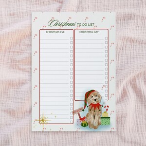 May include: A Christmas-themed to-do list notepad with a festive design. The notepad features a watercolor illustration of a dog wearing a Christmas elf hat and collar, surrounded by gifts and candy canes. The text "Christmas To Do List" is at the top.
