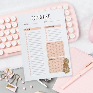May include: A white to-do list planner page featuring the text TO DO LIST at the top. The layout includes sections for month, date, to-do items, priorities, notes, and reminders, decorated with small paw print icons and a brown dog illustration.