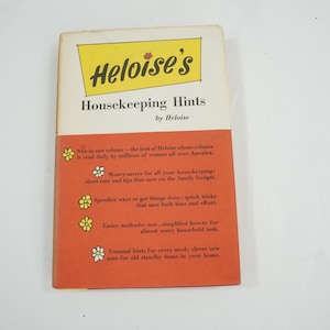 May include: A vintage paperback book titled "Heloise's Housekeeping Hints." The cover features a yellow rectangle with the title and a red and orange section with text and floral illustrations. The book is a guide to household tips.