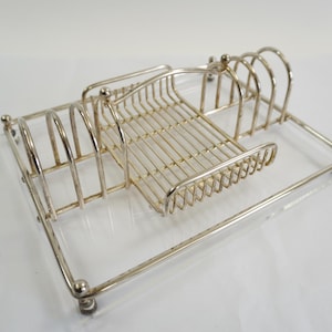 May include: A set of three ceramic mugs with a speckled, matte finish. The mugs are in shades of cream, light gray, and dark gray. Each mug has a simple, minimalist design and a rounded handle.