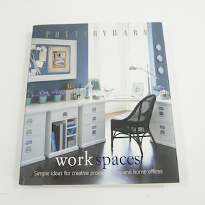May include: A book titled "Work Spaces: Simple Ideas for Creative Projects, Rooms, and Home Offices" by Pottery Barn. The cover features a white desk with drawers, a black wicker chair, and a blue wall with a framed corkboard.