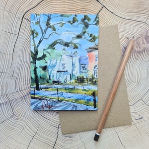 May include: Watercolor painting of a street scene with colorful houses and trees. The houses are painted in shades of blue, green, and pink. The trees are painted in shades of green and brown. The street is painted in shades of gray and blue.