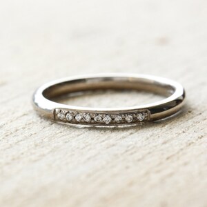 18ct white gold wedding ring with 9 pave set diamonds. UK size M. 18ct white gold eternity ring with G Si diamonds. image 3