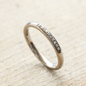 18ct white gold wedding ring with 9 pave set diamonds. UK size M. 18ct white gold eternity ring with G Si diamonds. image 4