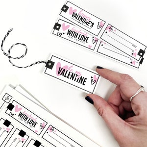 May include: Set of printable Valentine's Day gift tags with pink hearts and black text. The tags say "Happy Valentine's Day", "Handmade with Love Just for You", and "Be My Valentine".