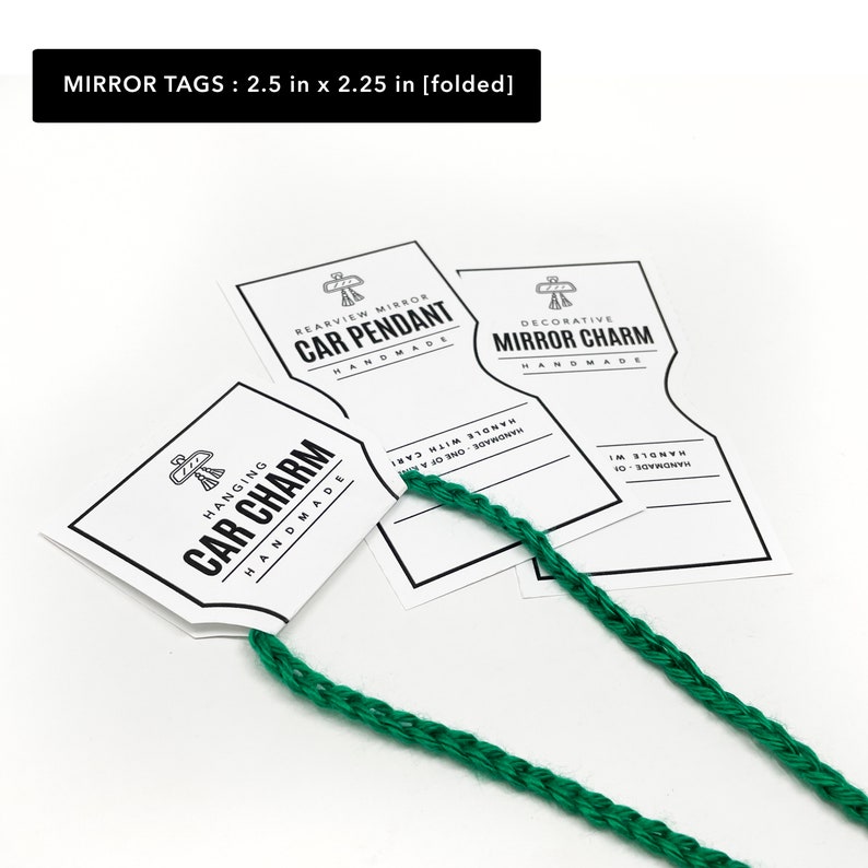 May include: Three white paper tags with black text and a small graphic of a stylized bird. The tags are for hanging car charms and read "Hanging Car Charm Handmade", "Rearview Mirror Car Pendant Handmade", and "Decorative Mirror Charm Handmade". The tags are attached to a green braided cord.