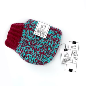 May include: A crocheted drink mitt in teal and burgundy colours. The mitt is handmade and has a tag that reads "Keep your drink cold and your hands warm. Drink Mitt. 100% Handmade."