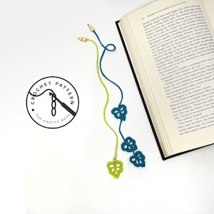 May include: Two crocheted bookmarks with leaf designs. One bookmark is green and the other is teal. Both bookmarks have wooden beads at the top.