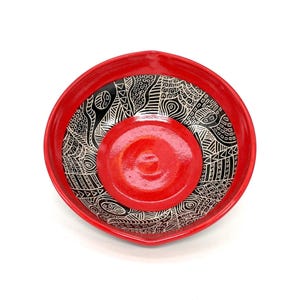Pottery bowl, Intricately carved with a sgraffito graphic design in a beautiful deep red