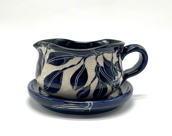 Pottery sauce/gravy boat in a lovely deep blue and carved with a leaf motif, sgraffito