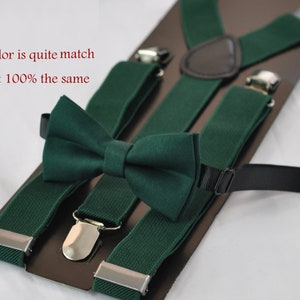 May include: A dark green bow tie and matching suspenders set with silver-toned metal clips and a brown leather-like back patch. The text "Color is quite match not 100% the same" is printed in red on the left side of the display card.