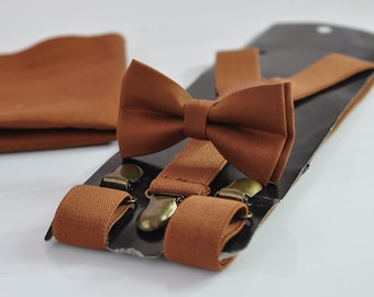 May include: A brown bow tie and suspenders set. The bow tie is made of a soft fabric and has a classic shape. The suspenders are adjustable and have metal clips.