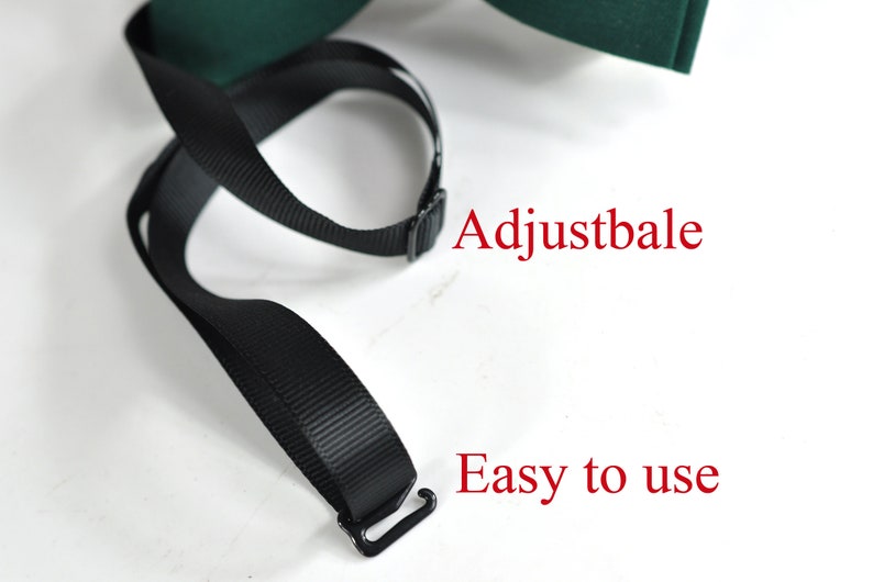 May include: A dark green bow tie featuring a black adjustable strap with a metal hook closure. The image includes the red text Adjustbale and Easy to use, highlighting the functional design of the neck strap mechanism for this accessory.