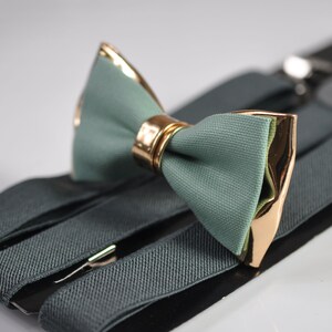 May include: A green bow tie with gold accents and a matching set of suspenders.