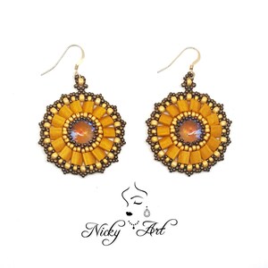 May include: A pair of gold and brown beaded earrings with a round, sun-like design. Each earring features a small, iridescent gemstone in the centre.
