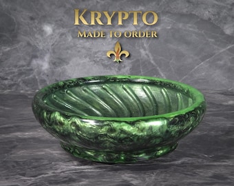 May include: A green decorative bowl with a swirled design. The bowl has a glossy finish and a wide, shallow shape. The text "KRYPTO MADE TO ORDER" is in gold above the bowl.
