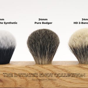 A display showing the knots available in the Initiates collection, show a synthetic Black and white knot, a pure badger knot, and a high density 2 band badger knot, all in a 24mm diameter.