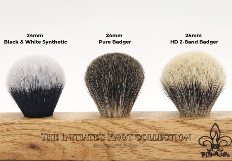 A display showing the knots available in the Initiates collection, show a synthetic Black and white knot, a pure badger knot, and a high density 2 band badger knot, all in a 24mm diameter.