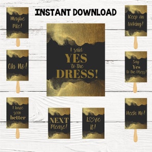 May include: Set of 10 printable bridal shower game cards with gold glitter and black background. The cards feature funny phrases like "I said yes to the dress!" and "Heck no!"