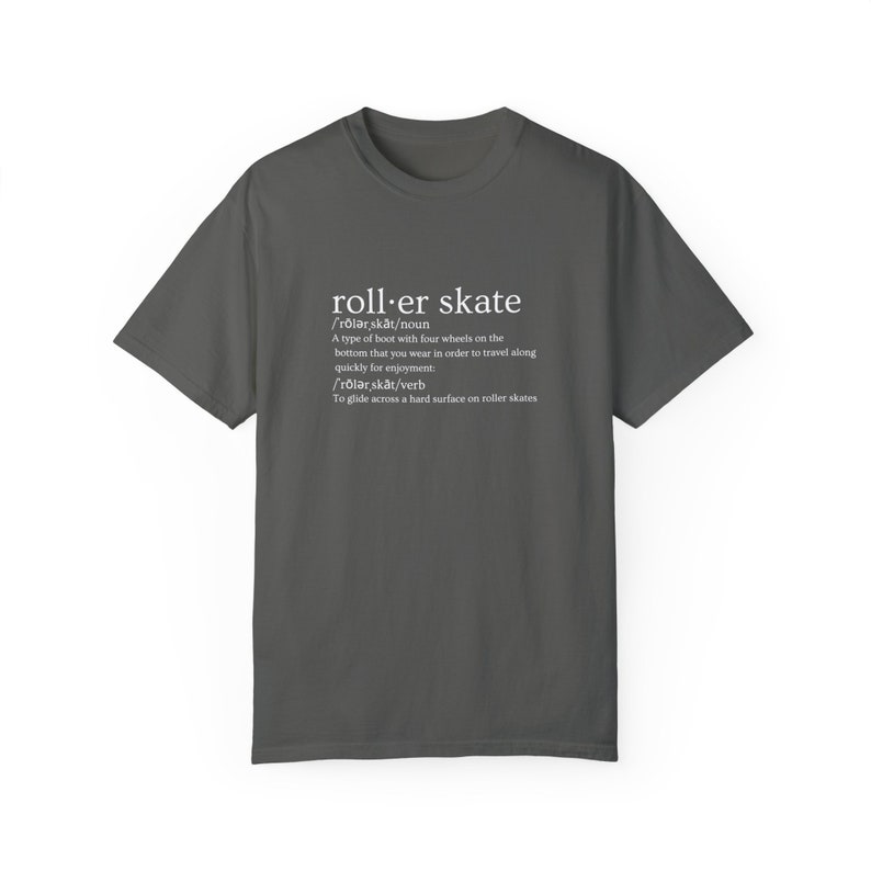 May include: A dark gray t-shirt with a white graphic design that defines the word "roller skate" as a type of boot with four wheels and a verb meaning to glide across a hard surface on roller skates.