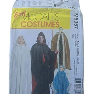 May include: A McCall's costume pattern envelope featuring illustrations of various hooded cloaks and robes. The envelope has the text "Easy McCall's Costumes" in yellow and the pattern number M5957.