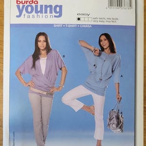 May include: A Burda Young Fashion sewing pattern envelope, number 7678, featuring illustrations of two shirt styles. The package displays European sizes 36-48 and US sizes 10-22, labeled as easy to sew, with text including ALL PATTERNS WITH SEAM AND HEM ALLOWANCES.
