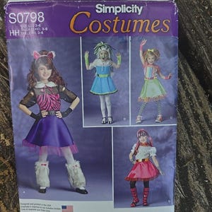 May include: A Simplicity Costumes sewing pattern envelope S0798 for sizes 3-6. The front displays four different costume designs for children, including a purple skirt outfit, a blue dress, a rainbow top with green skirt, and a pink skirt ensemble.