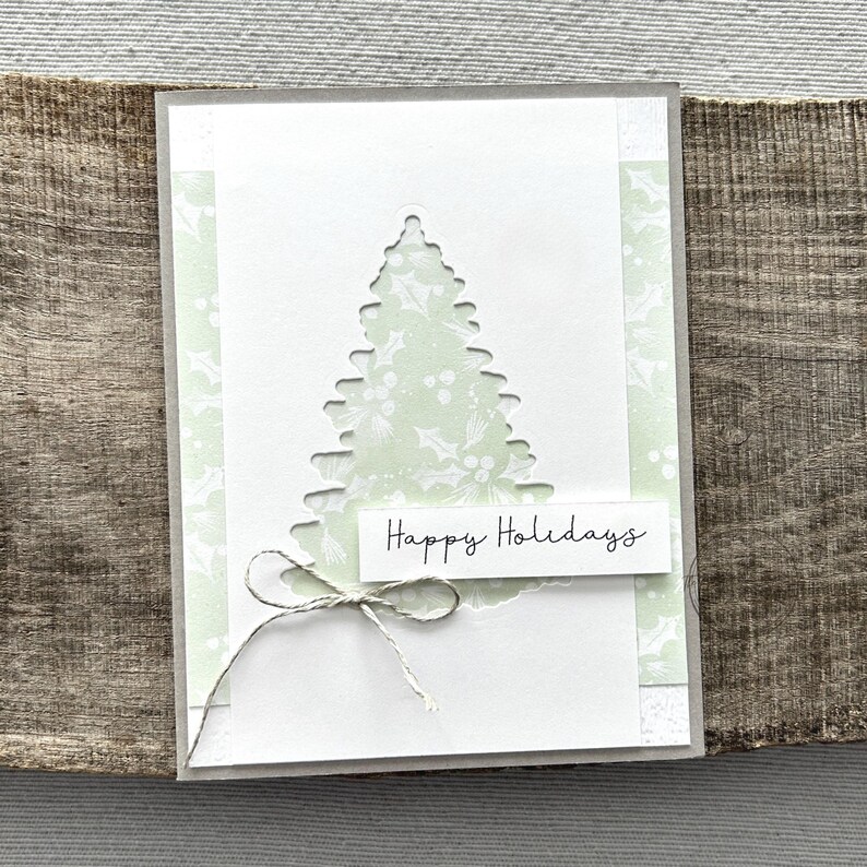 A finished card, from this card making kit, sitting on a wooden board.