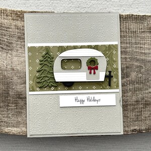 A finished card, from this card making kit, sitting on a wooden board.